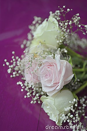 A Beautiful bouquet of flowers with white buds on purple sheet Stock Photo