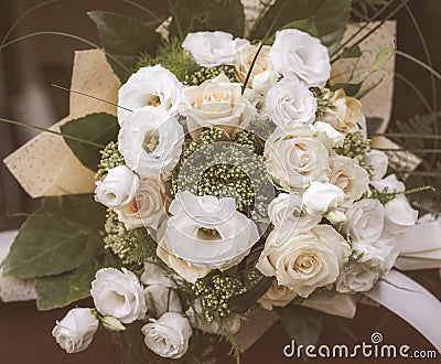 Beautiful bouquet of fresh rose flower and eustoma in cream and white colors. Floral backdrop. Toning in vintage style Stock Photo