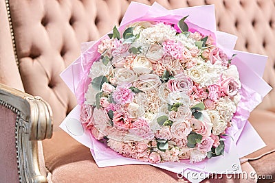 Beautiful bouquet of mixed flowers on a vintage sofa. the work of the florist at a flower shop. Delivery fresh cut Stock Photo