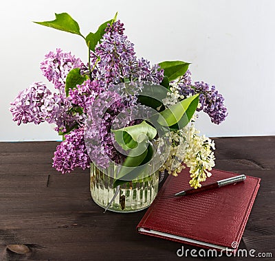 A beautiful bouquet in a vase. A bouquet of lilac branches in a beautiful jar. Stock Photo