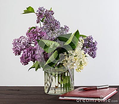 A beautiful bouquet in a vase. A bouquet of lilac branches in a beautiful jar. Stock Photo