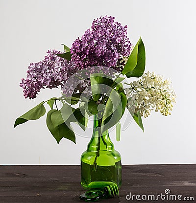 A beautiful bouquet in a vase. A bouquet of lilac branches in a beautiful jar. Stock Photo