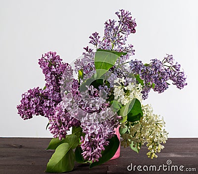 A beautiful bouquet in a vase. A bouquet of lilac branches in a beautiful jar. Stock Photo