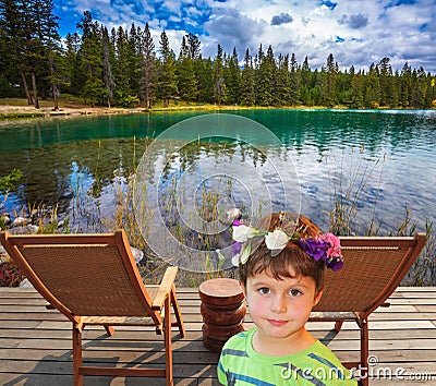 The beautiful boy on the bank of round lake Stock Photo