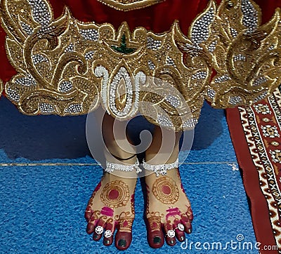 Beautiful bride's feet with mehndi design Stock Photo