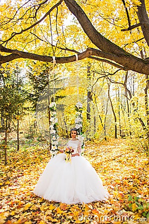 Beautiful bride in the autumn park Stock Photo
