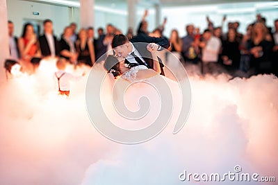 Beautiful bride and handsome groom dancing first dance at the wedding party. Stock Photo