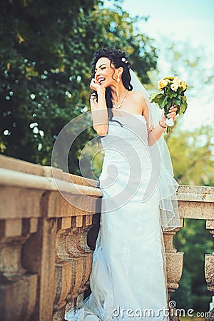 Beautiful bride holding wedding colorful bouquet. Beauty of colored flowers. Bridal accessories for girl Stock Photo