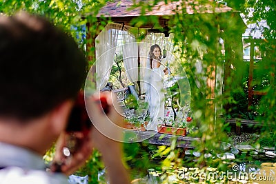 bride with bouquet of lilies kalla in a gazebo. backstage wedding photo shoot Stock Photo