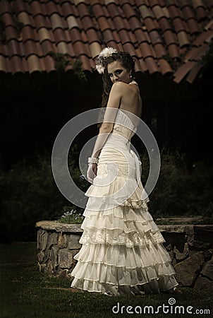 Beautiful bride looking flirtatiously over her shoulder Stock Photo