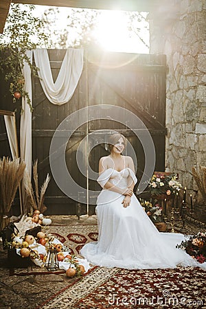 Beautiful bride in rustic arrangement by sunset Stock Photo