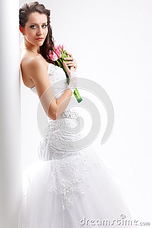 Beautiful bride standing near white column Stock Photo