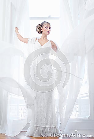 Beautiful Bride Standing By Open Window Stock Photo