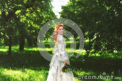 Beautiful bride in summer colorful park. Girl in vintage dress. Stock Photo