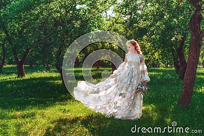 Beautiful bride in summer green park. Girl in vintage dress. Stock Photo