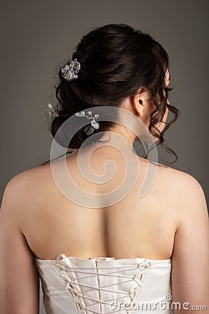Bride in white dress with bouquet in photostudio Stock Photo