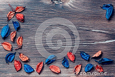 Beautiful bright original elegant floral wooden background flatlay with multicolored blue and orange dried flowers with copy space Stock Photo