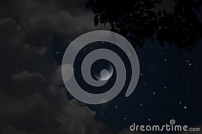 Bright stars and clouds in crescent night Stock Photo