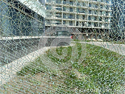 Beautiful broken anti-vandal transparent shiny cracked glass. The background. Texture Stock Photo