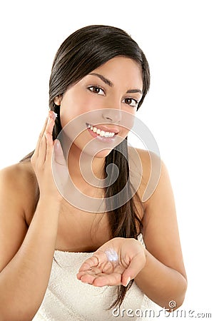 Beautiful brunette applying cosmetic cream Stock Photo