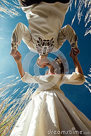 Beautiful brunette bride and elegant stylish groom with true happy feelings kissing in a sunny field, life concept Stock Photo