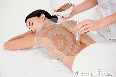 Beautiful brunette enjoying a chocolate beauty treatment Stock Photo