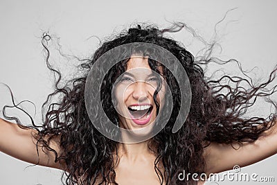 Beautiful brunette girl with long wet hair, studio portrait. Very happy smiling expression Stock Photo