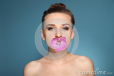 Beautiful brunette girl with orchid flowers Stock Photo