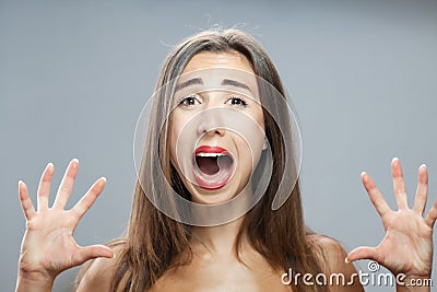 Beautiful brunette girl studio portrait. Screaming and surprised expression Stock Photo