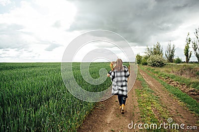 Beautiful brunette lady in wheat field at sunset. Happy beautiful woman in meadow. Stock Photo