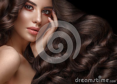 Beautiful brunette model: curls, classic makeup and full lips. The beauty face. Stock Photo