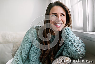 Candid lifestyle head shot of beautiful young woman smiling at home, perfect straight white teeth and cheerful expression Stock Photo