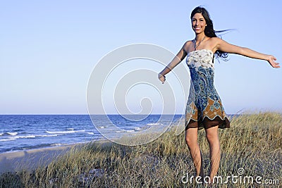 Beautiful brunette posing on the beach Stock Photo