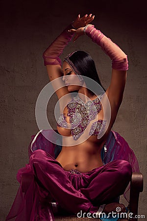 Beautiful brunette woman in afghani pants, purdah and adornment Stock Photo