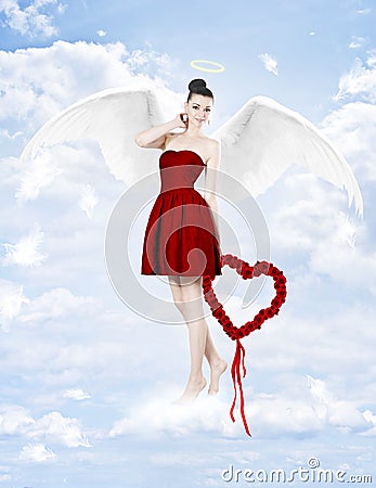 Beautiful brunette woman as cupid with heart made of roses Stock Photo