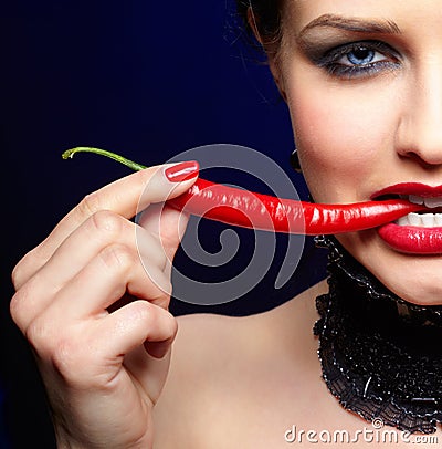 Beautiful brunette woman with chili pepper Stock Photo