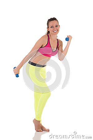 Beautiful brunette woman doing exercises for muscles back, hands, legs and buttocks using dumbbells. Stock Photo