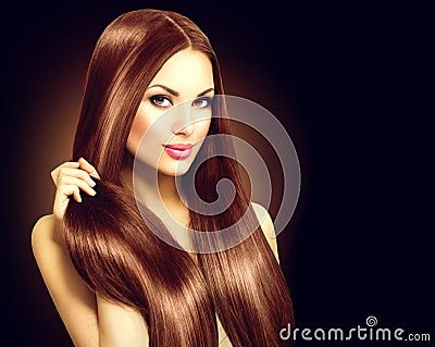 Beautiful brunette woman touching her long hair Stock Photo