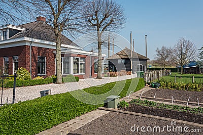 Beautiful bungalow with kitchen garden and a hay loft converted into a home situated between huge greenhouses Editorial Stock Photo