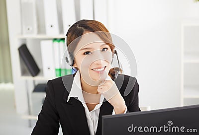 Beautiful businesswoman with headset in office Stock Photo