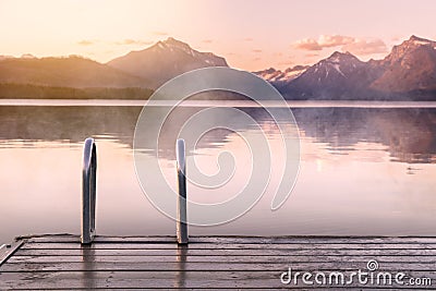 Beautiful calm peaceful scenic foggy lake and mountains view from wood decking, relaxation, tranquility, wanderlust Stock Photo