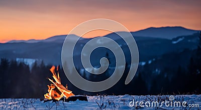 BEAUTIFUL CAMPFIRE IN THE MIDDLE OF A LAYER OF SNOW Stock Photo