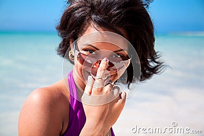Beautiful caribbean brunette with sunglasses Stock Photo