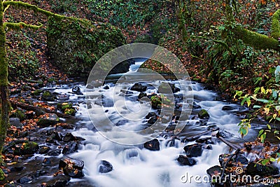 Beautiful Cascade stream through the rocks in fall Stock Photo