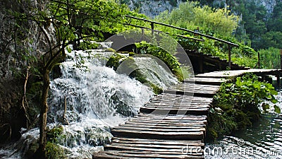 Beautiful cascade waterfalls and wooden pathway over the water, Plitvice Lakes in Croatia, National Park Stock Photo