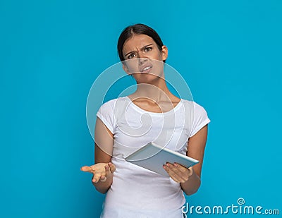 Beautiful casual woman can`t understand something on her tablet Stock Photo