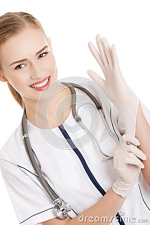 Beautiful caucasian doctor or nurse putting white sterile glove. Stock Photo