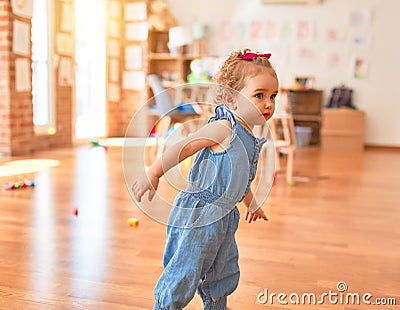 Beautiful caucasian infant playing with toys at colorful playroom Stock Photo