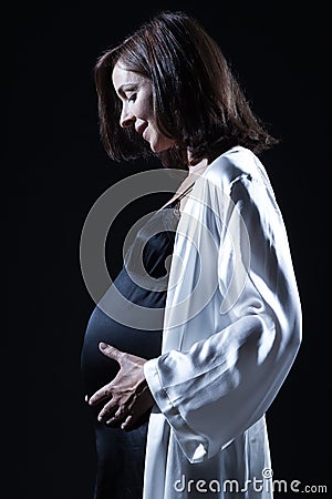 Beautiful caucasian pregnant woman in nightie Stock Photo