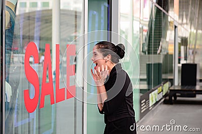 Beautiful caucasian woman excited when see the price tag on sale clothing fashion at the store Stock Photo